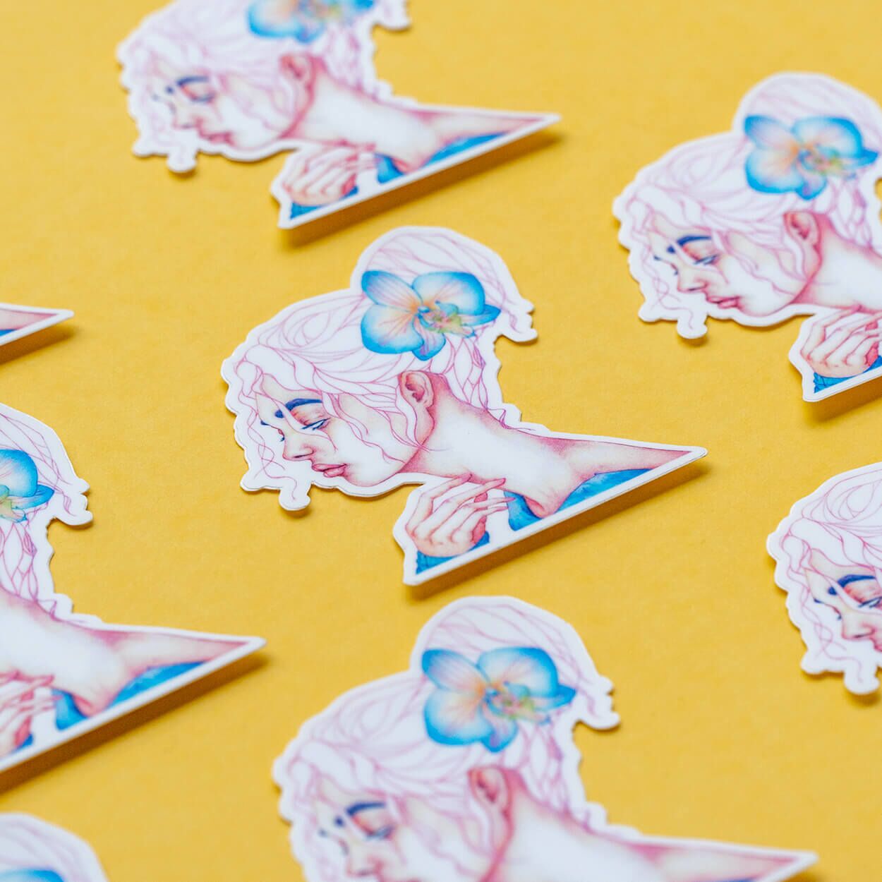 Peripheral sticker product focus lined in a diagonal fashion over a yellow backdrop